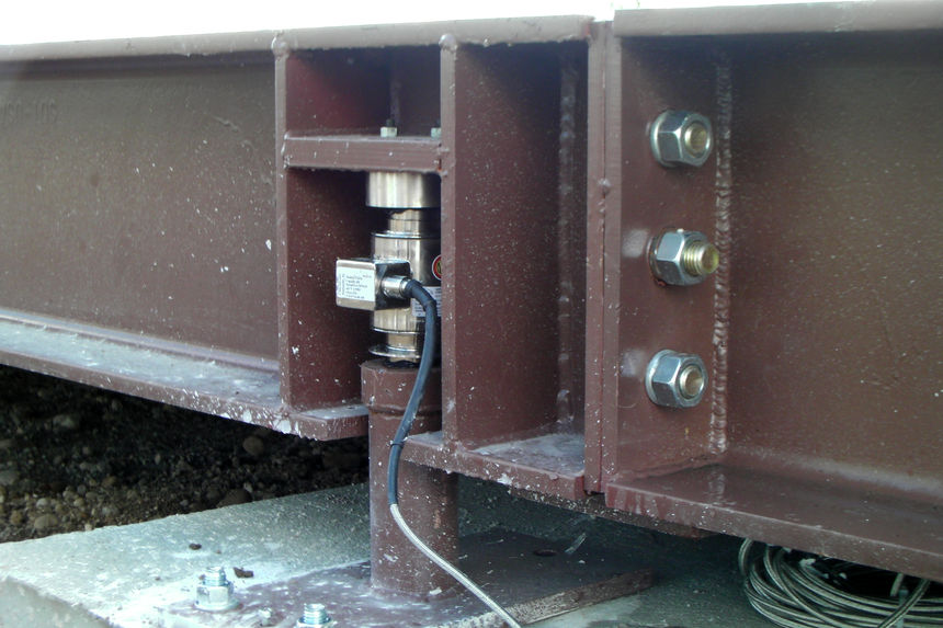 Weighing scale, a close up of its steel and concrete construction and a load cell